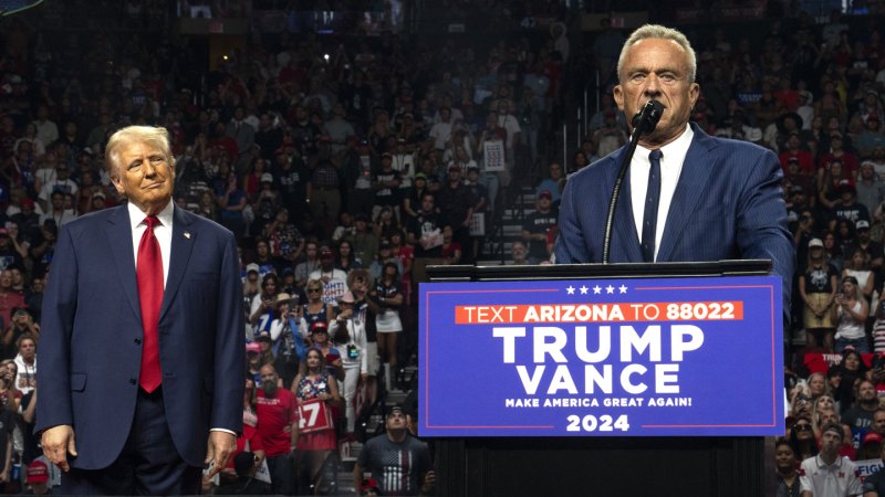 Robert F. Kennedy Jr. speaks into a microphone from behind a podium at a Trump rally in Arizona during the 2024 presidential campaign.